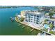 Aerial view of waterfront building with boat slips and pool at 211 Dolphin Pt # 401, Clearwater, FL 33767