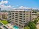 Beautiful condominium exterior featuring multiple balconies and a refreshing community pool at 125 Island Way # 304, Clearwater, FL 33767