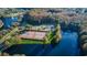 Aerial view of community tennis courts near a lake at 4931 Ridgemoor Cir, Palm Harbor, FL 34685