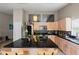 Modern kitchen with a large island, stainless steel appliances, and light wood cabinets at 4931 Ridgemoor Cir, Palm Harbor, FL 34685