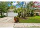 House exterior featuring a well-maintained lawn and attractive landscaping at 4931 Ridgemoor Cir, Palm Harbor, FL 34685