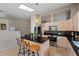 Bright kitchen features an island with seating, stainless steel appliances, and light wood cabinets at 4931 Ridgemoor Cir, Palm Harbor, FL 34685
