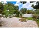 Spacious backyard with a brick paved patio and lush landscaping at 4931 Ridgemoor Cir, Palm Harbor, FL 34685