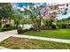 House with blooming tree and landscaped yard at 4931 Ridgemoor Cir, Palm Harbor, FL 34685