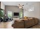 Relaxing living room with sectional sofa, ceiling fan, and access to the patio at 4931 Ridgemoor Cir, Palm Harbor, FL 34685