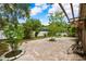 Large backyard with brick paved patio, landscaping, and pergola at 4931 Ridgemoor Cir, Palm Harbor, FL 34685