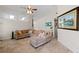 Open living area featuring a comfortable sectional sofa and large windows at 4931 Ridgemoor Cir, Palm Harbor, FL 34685