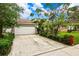 House with a white garage door and driveway at 4931 Ridgemoor Cir, Palm Harbor, FL 34685
