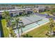 Tennis and shuffleboard courts surrounded by tropical greenery and condo buildings at 12300 Vonn Rd # 3204, Largo, FL 33774