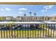 Balcony view showcasing the building's design, carport, and landscaping with palm trees at 12300 Vonn Rd # 3204, Largo, FL 33774