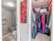 Tiled bathroom with a shower featuring elegant marble-patterned walls and a niche for toiletries at 12300 Vonn Rd # 3204, Largo, FL 33774