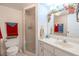 Bright bathroom with a glass-enclosed shower, vanity with solid surface counter, and decorative mirror at 12300 Vonn Rd # 3204, Largo, FL 33774