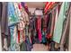 Walk-in closet filled with an array of clothing and storage bins, offering ample organizational space at 12300 Vonn Rd # 3204, Largo, FL 33774