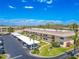 Condo building features covered parking, a well-maintained lawn, and mature landscaping for added privacy at 12300 Vonn Rd # 3204, Largo, FL 33774