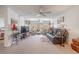 Inviting living room featuring a comfortable recliner, television, and seamless access to a sunroom at 12300 Vonn Rd # 3204, Largo, FL 33774