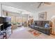 Bright living area with a comfortable sofa, sunroom access, and relaxing ambiance at 12300 Vonn Rd # 3204, Largo, FL 33774