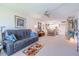 Cozy living space with a sectional sofa, dining table, and a view into the kitchen at 12300 Vonn Rd # 3204, Largo, FL 33774
