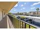 View from condo balcony showing parking lot with designated covered spaces and palm trees at 12300 Vonn Rd # 3204, Largo, FL 33774