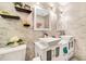 Bathroom with double vanity and marble-look tile at 12476 Jaybird Rd, Weeki Wachee, FL 34614
