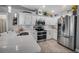 Modern kitchen with white cabinets, stainless steel appliances, and quartz countertops at 12476 Jaybird Rd, Weeki Wachee, FL 34614