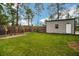 Landscaped backyard with garden and metal storage shed at 12476 Jaybird Rd, Weeki Wachee, FL 34614