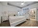 Spacious primary bedroom with white furniture and wood floors at 12476 Jaybird Rd, Weeki Wachee, FL 34614