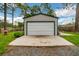 Detached garage with large roll-up door and concrete pad at 12476 Jaybird Rd, Weeki Wachee, FL 34614