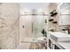 Elegant bathroom with marble shower and modern vanity at 12476 Jaybird Rd, Weeki Wachee, FL 34614