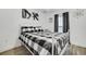 Bedroom with white metal bed frame and black and white bedding at 12476 Jaybird Rd, Weeki Wachee, FL 34614