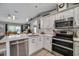 Modern kitchen with stainless steel appliances and white cabinets at 12476 Jaybird Rd, Weeki Wachee, FL 34614