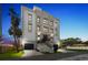 An elegant exterior view of a multi-story home, featuring dual garages and a meticulously landscaped front yard at 3087, 3075 Cherry Ln, Clearwater, FL 33759