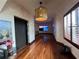 Long hallway with hardwood floors, elevator, and large art at 3087, 3075 Cherry Ln, Clearwater, FL 33759