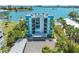 Exterior view of a light teal building with balconies overlooking the water at 1848 Shore S Dr # 501, South Pasadena, FL 33707