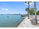 Relaxing waterfront pathway with a bench and palm trees at 1848 Shore S Dr # 501, South Pasadena, FL 33707