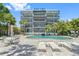 Inviting community pool with lounge chairs and patio tables at 1848 Shore S Dr # 501, South Pasadena, FL 33707