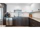 Modern kitchen with dark wood cabinets, stainless steel appliances and white upper cabinets at 1848 Shore S Dr # 501, South Pasadena, FL 33707