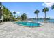 Inviting community pool with patio area, lush landscaping, and waterfront access at 1848 Shore S Dr # 501, South Pasadena, FL 33707