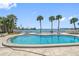 Kidney-shaped community pool with surrounding patio and water views at 1848 Shore S Dr # 501, South Pasadena, FL 33707