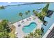 Aerial view of resort-style pool, patio area with lounge chairs, and waterfront views at 1848 Shore S Dr # 501, South Pasadena, FL 33707