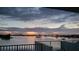 Scenic water view featuring calm waters and a cityscape silhouette against a dramatic, cloud-filled evening sky at 1848 Shore S Dr # 501, South Pasadena, FL 33707