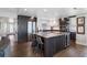 Modern kitchen with a large island, dark cabinetry, and stainless steel appliances at 1848 Shore S Dr # 501, South Pasadena, FL 33707