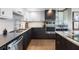 Modern kitchen with dark wood cabinets, stainless steel appliances, and a stylish backsplash at 1848 Shore S Dr # 501, South Pasadena, FL 33707