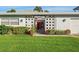 Mid-century modern home with red door at 429 3Rd N Ave, Tierra Verde, FL 33715