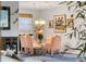 Elegant dining room with a glass table, pink chairs, and beautiful artwork on the walls at 429 3Rd N Ave, Tierra Verde, FL 33715