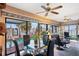 Bright sunroom with water view, comfortable seating, and a glass dining table at 429 3Rd N Ave, Tierra Verde, FL 33715