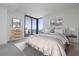 Virtually staged bedroom with large windows offering city views; neutral color palette and ample natural light at 301 1St Street South # 2304, St Petersburg, FL 33701