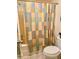 Full bathtub and toilet combination with multicolored shower curtain at 1655 S Highland Ave # J194, Clearwater, FL 33756