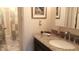 Bathroom with brown granite counter, decorative mirror, and tiled shower/tub at 1655 S Highland Ave # J194, Clearwater, FL 33756