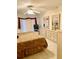 Bright bedroom features tile flooring, a ceiling fan and neutral paint at 1655 S Highland Ave # J194, Clearwater, FL 33756
