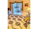 Bedroom featuring natural light from sliding glass door to patio at 1655 S Highland Ave # J194, Clearwater, FL 33756